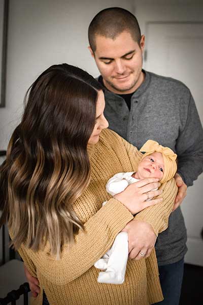 Couple with the baby daughter in their new home.