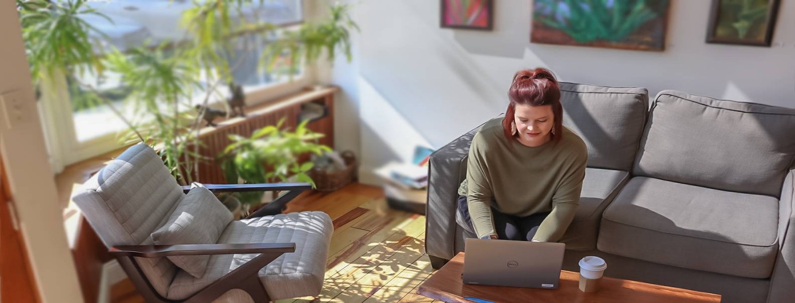 Friendship State Bank customer accessing the bank website from her laptop from the couch.