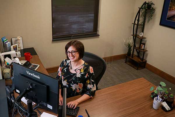 Batesville lender, Shayla Sattler, at desk in office.