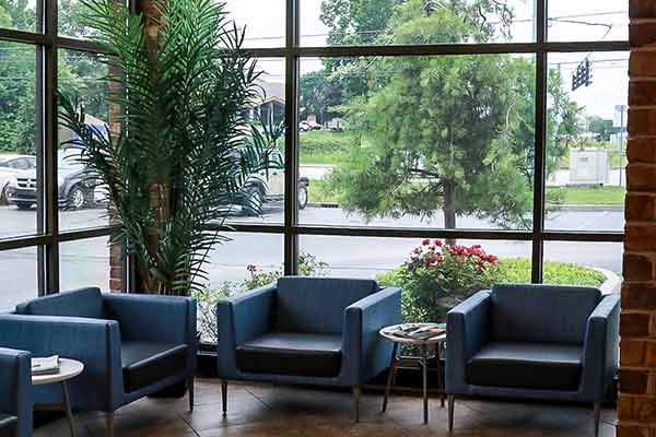 Batesville branch lobby with blue chairs and white round end tables.