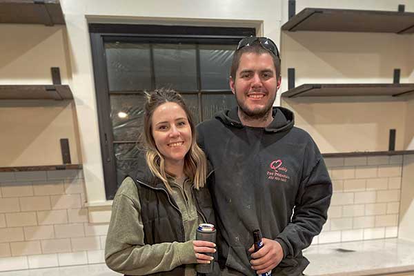 Homeowners in their kitchen during the construction process.